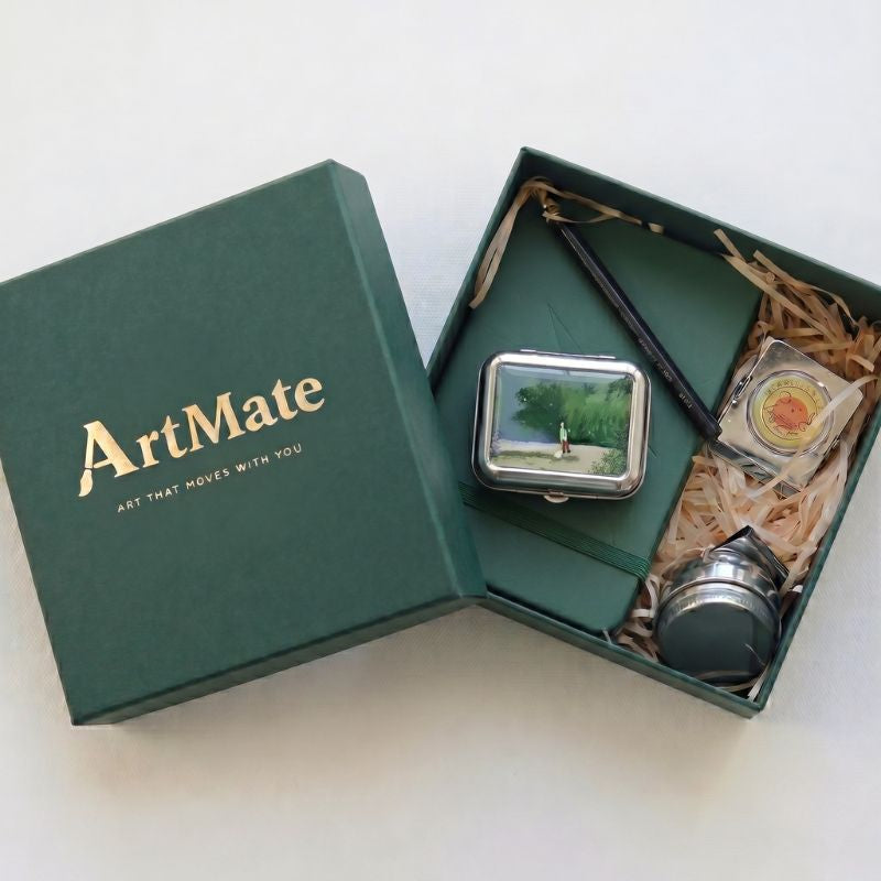 Travel painting kit presented in a black gift box with a dried flower and gift tag