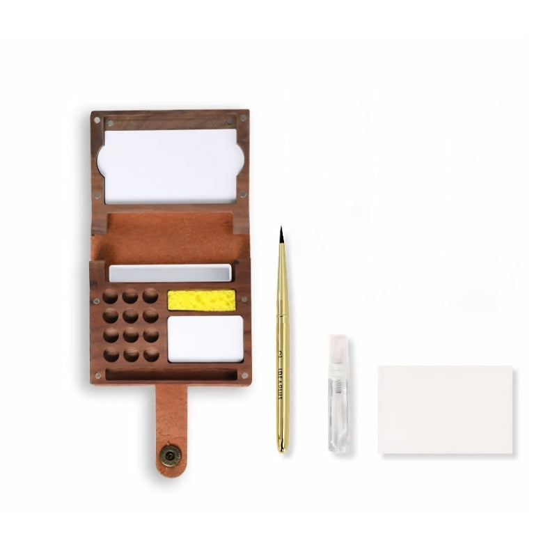 Flat-lay of the walnut folio kit contents: folding case, telescopic brush, water sprayer, sponge and paper