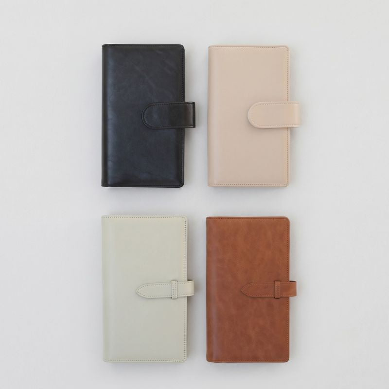 Four closed ArtMate Voyager leather kits in Classic Black, Cream Apricot, Spruce Green and Classic Brown with snap-tab closures